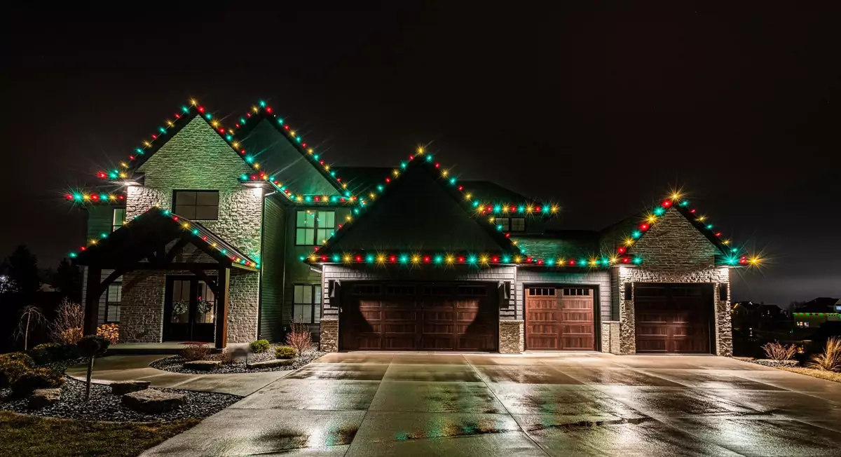 Two-story home with three garages, every roofline in multicolor C9 bulbs